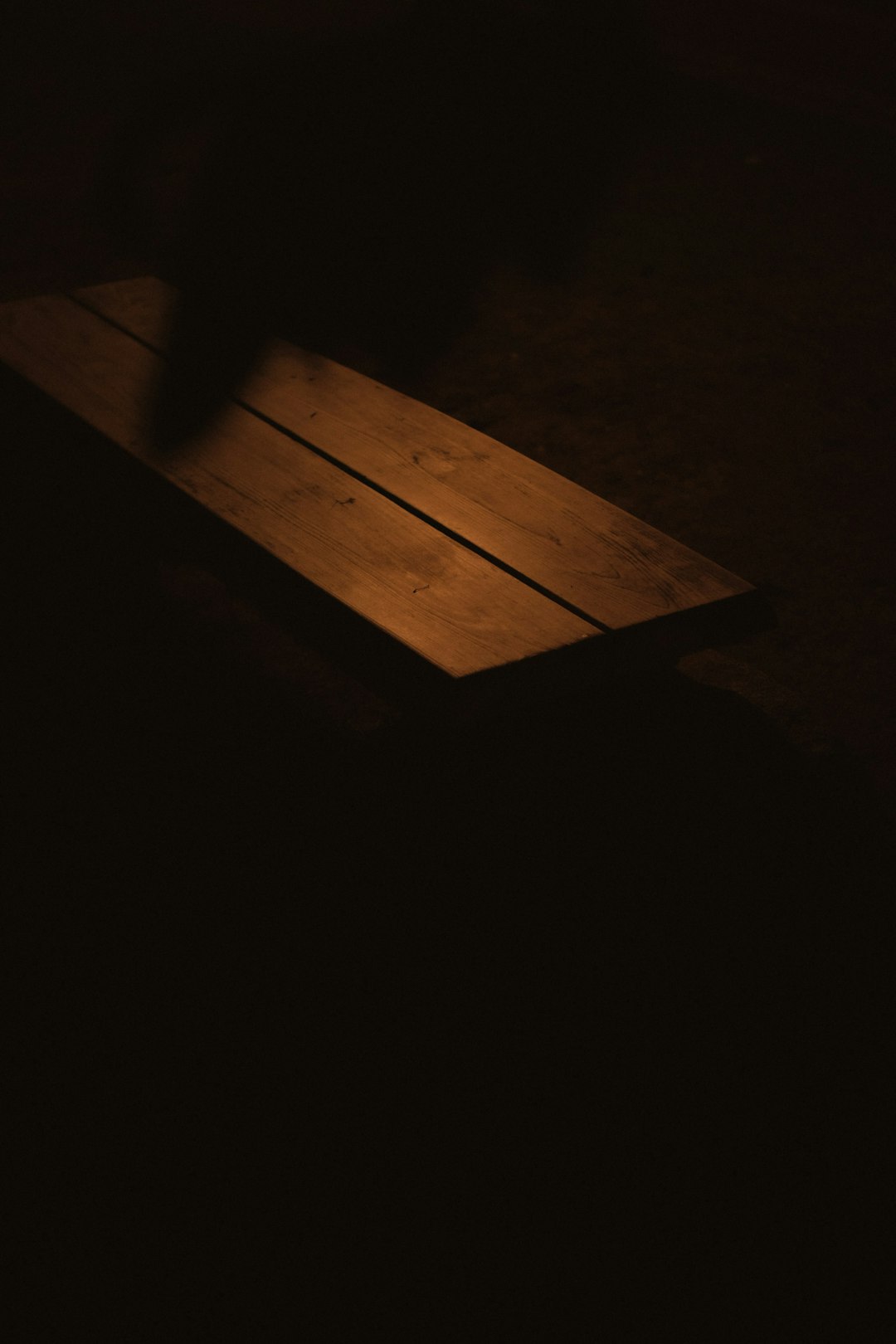 brown wooden plank on black surface