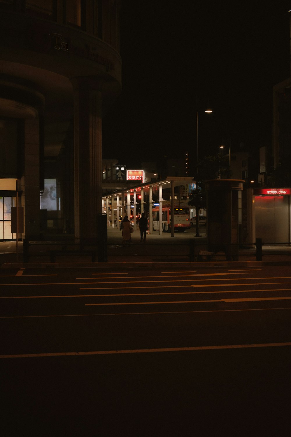 people walking on sidewalk during night time