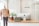 A neatly arranged retail space featuring a mannequin dressed in a casual shirt and trousers. On the counter is an Apple desktop computer, a potted plant, and a Marshall speaker. The decor is minimalist with a clean and organized aesthetic. The name 'allee blue' is displayed on the wall.