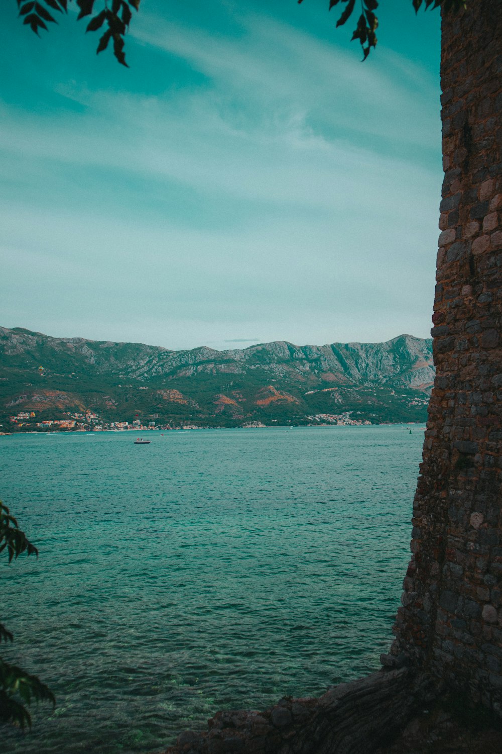 brown rock formation near body of water during daytime