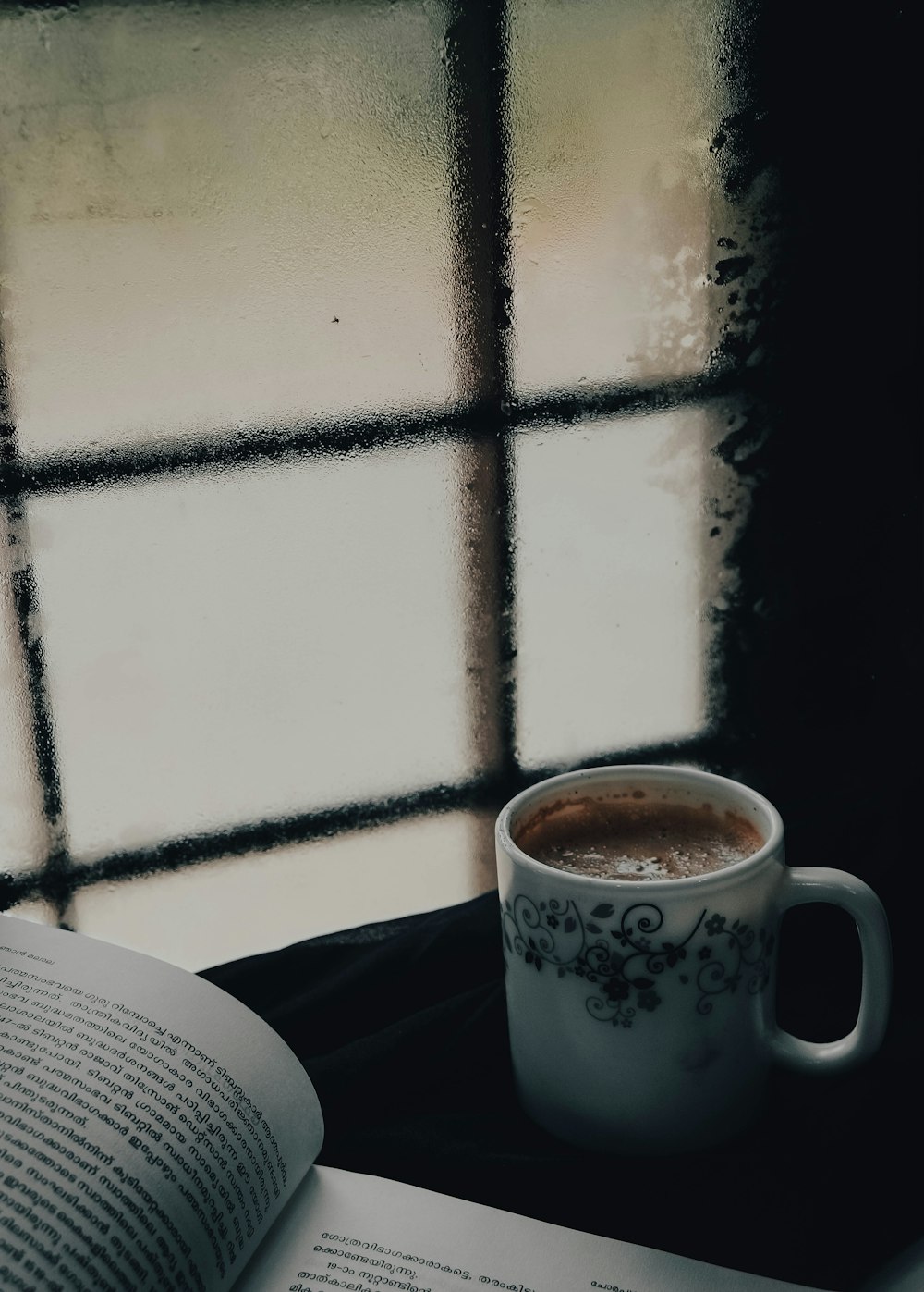 white ceramic mug on black table