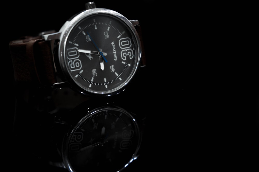 silver and black round analog watch