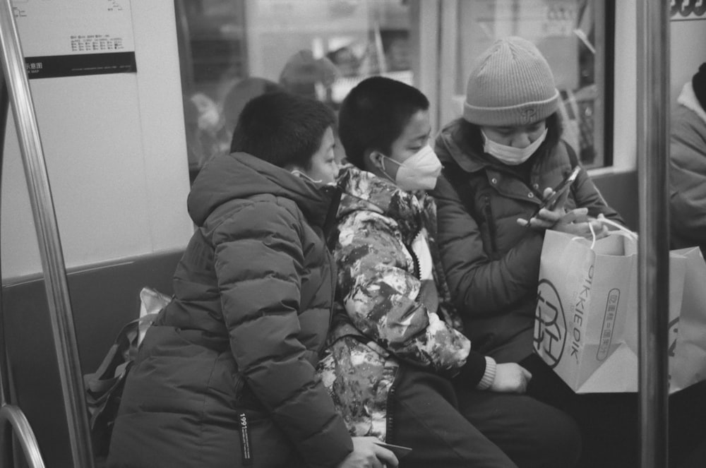 man in brown jacket sitting beside man in brown jacket