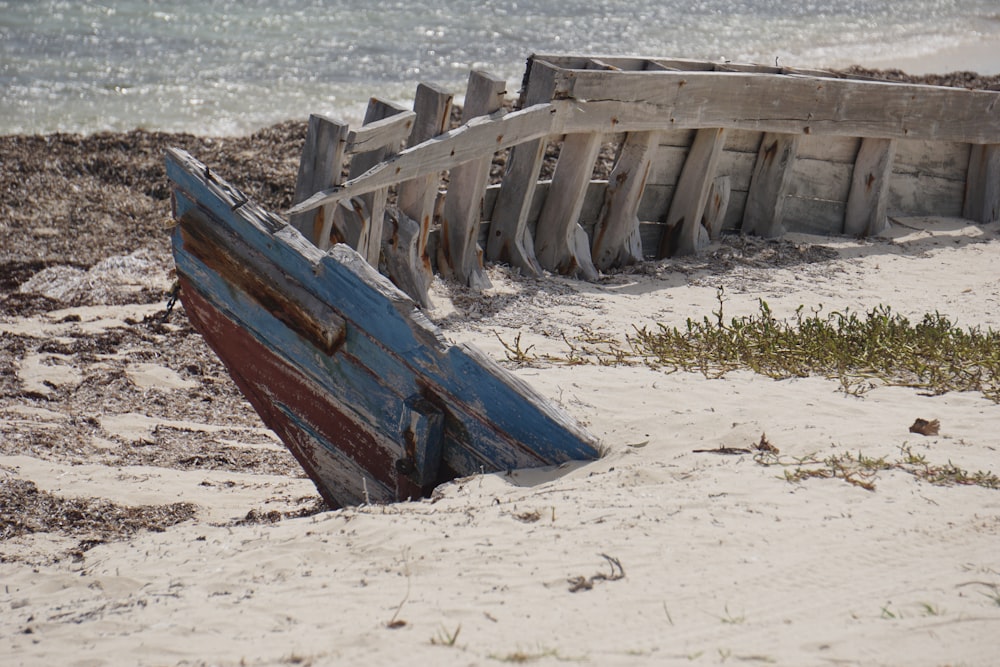 brown wooden boat on white sand during daytime