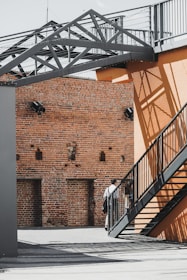 black steel fence near brown concrete building during daytime