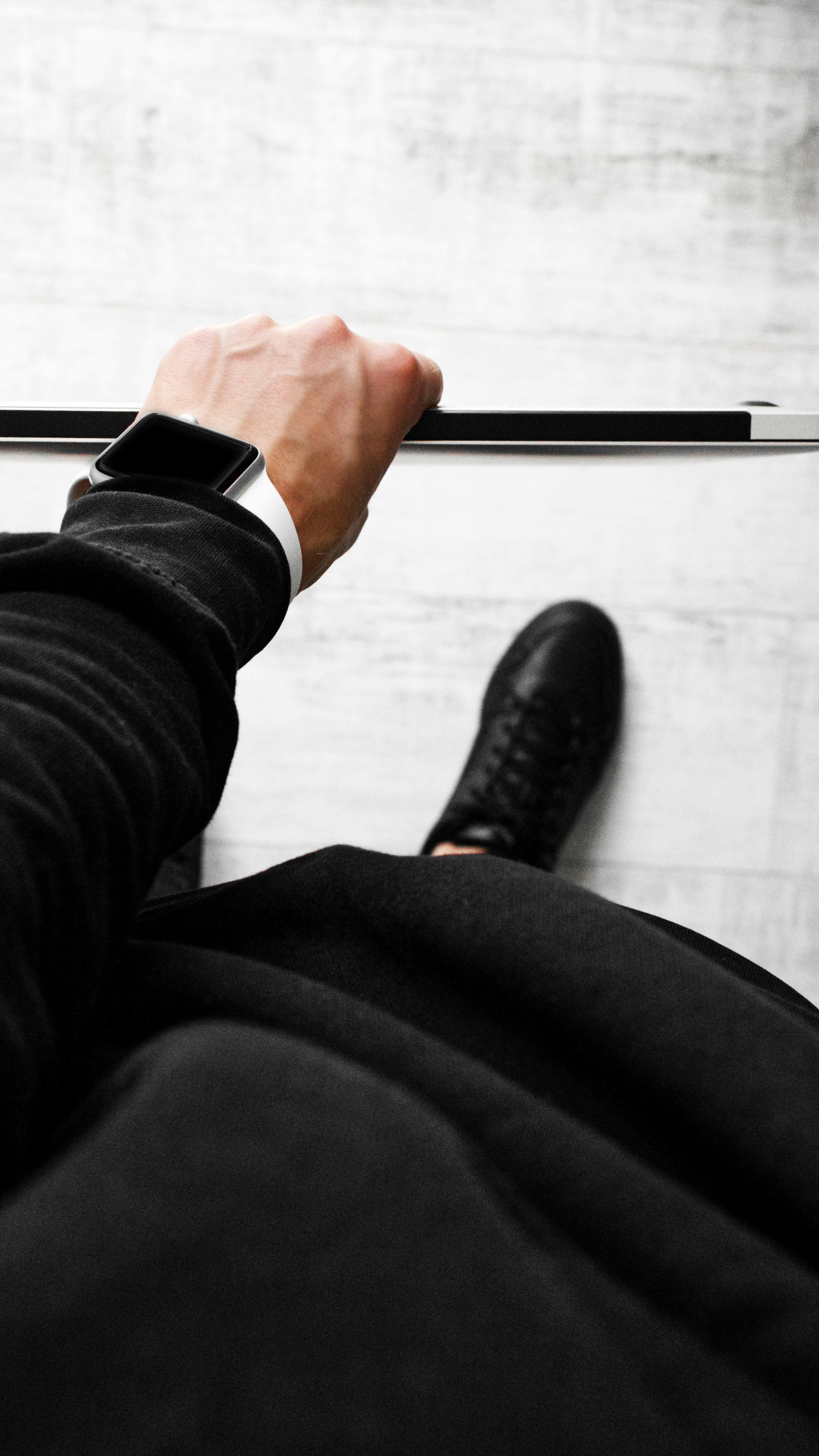 person in black long sleeve shirt holding black pen