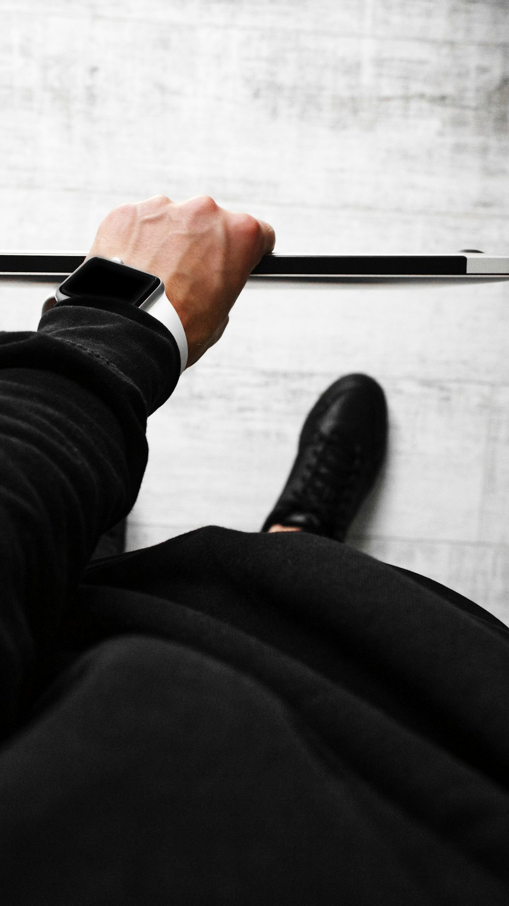 person in black long sleeve shirt holding black pen