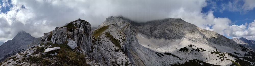 gray and green mountain under white clouds during daytime