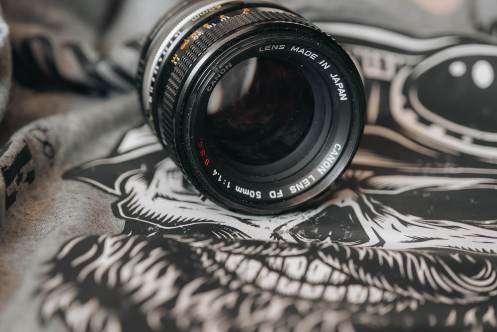 black camera lens on white and black textile