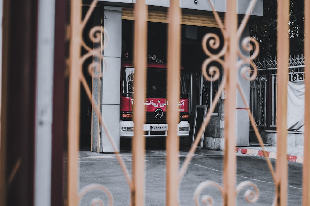 red bus on road during daytime