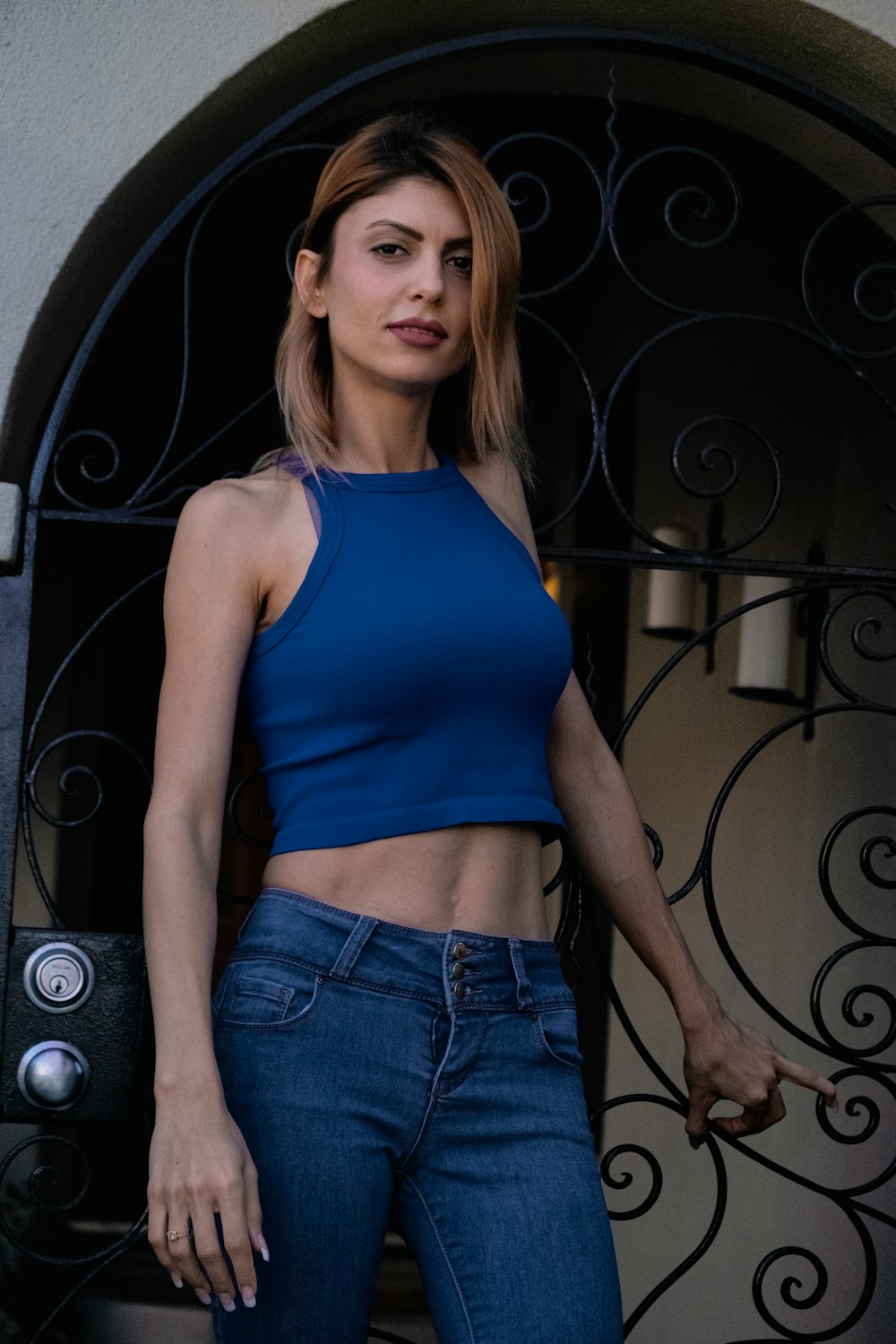 woman in blue tank top and blue denim shorts