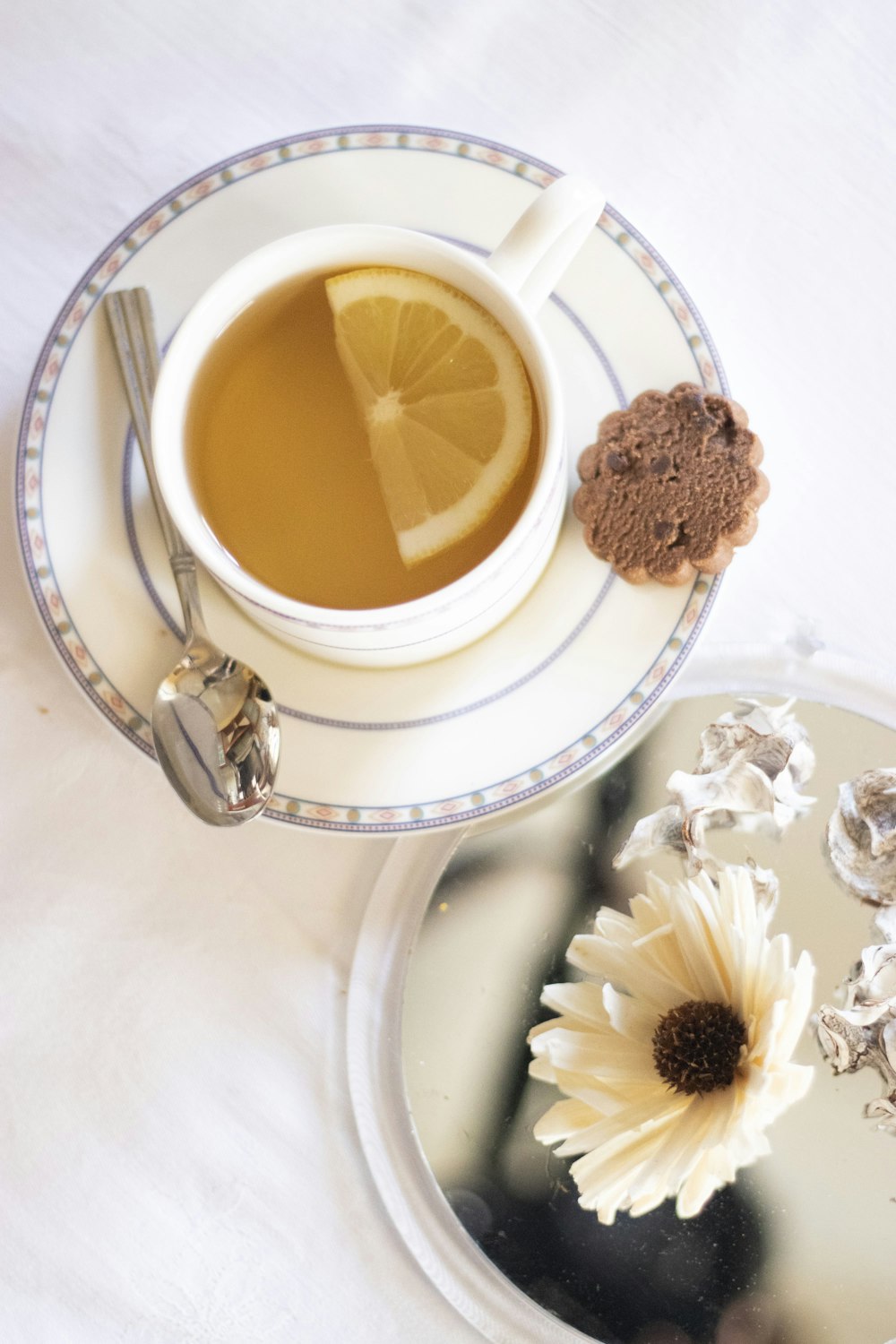 white ceramic cup with yellow liquid inside