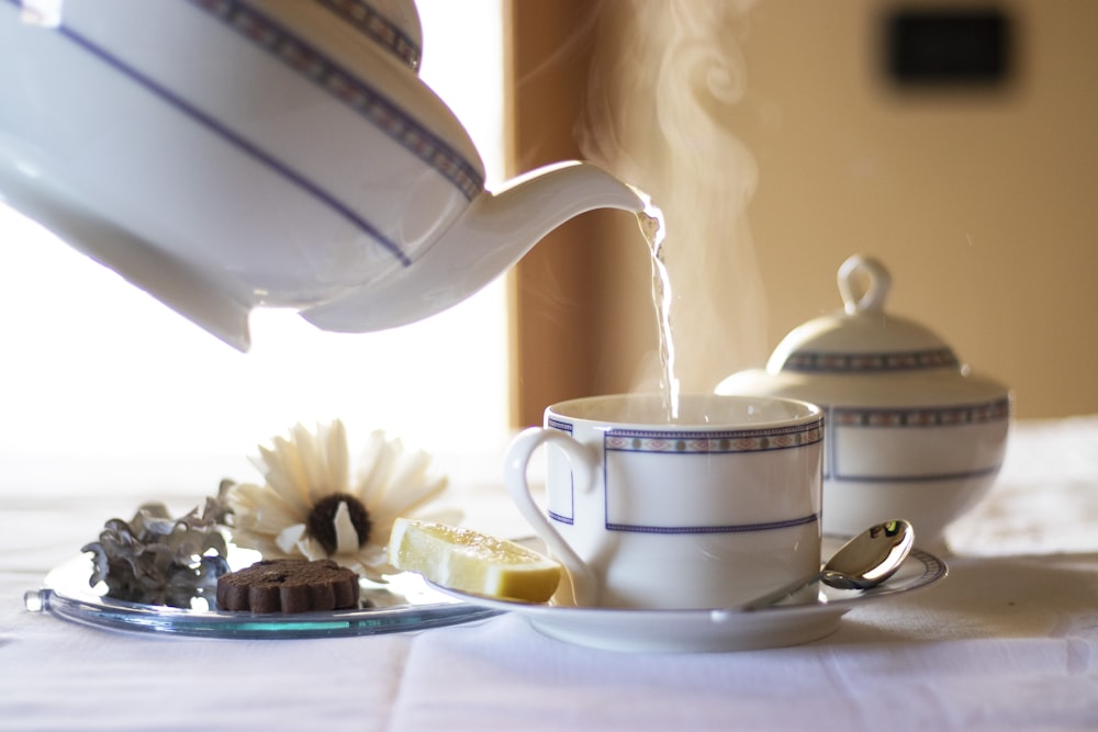 white ceramic teapot on white ceramic saucer