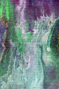 Close-up of a pastel purple and green abstract painting on canvas