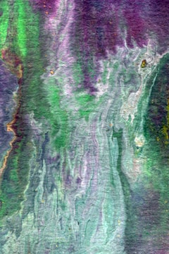Close-up of a pastel purple and green abstract painting on canvas