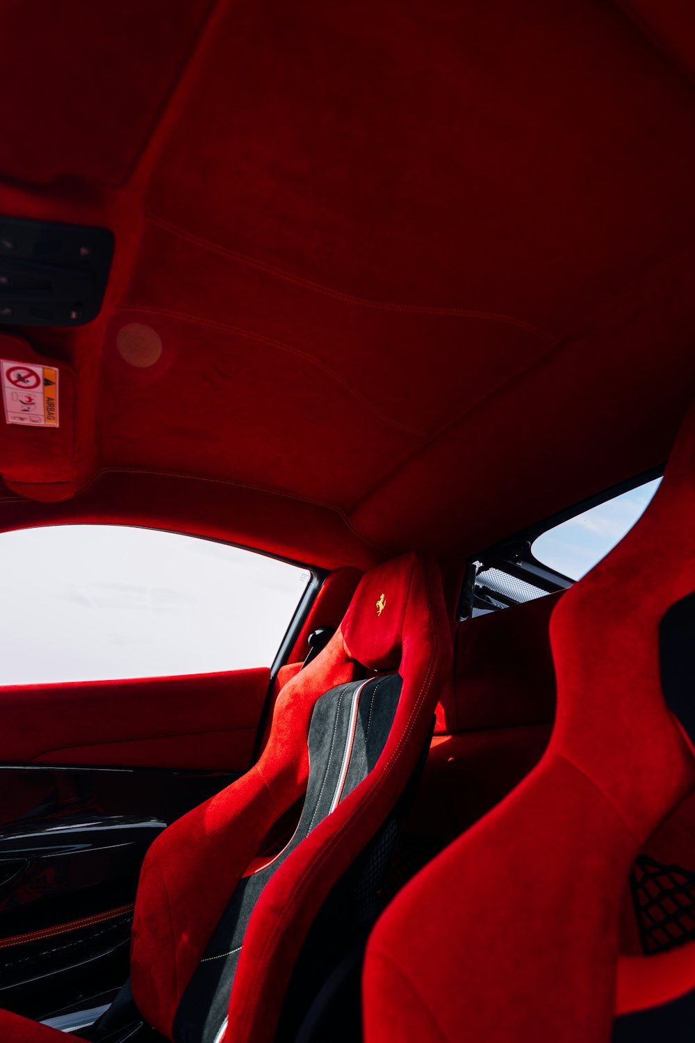 red car steering wheel during daytime