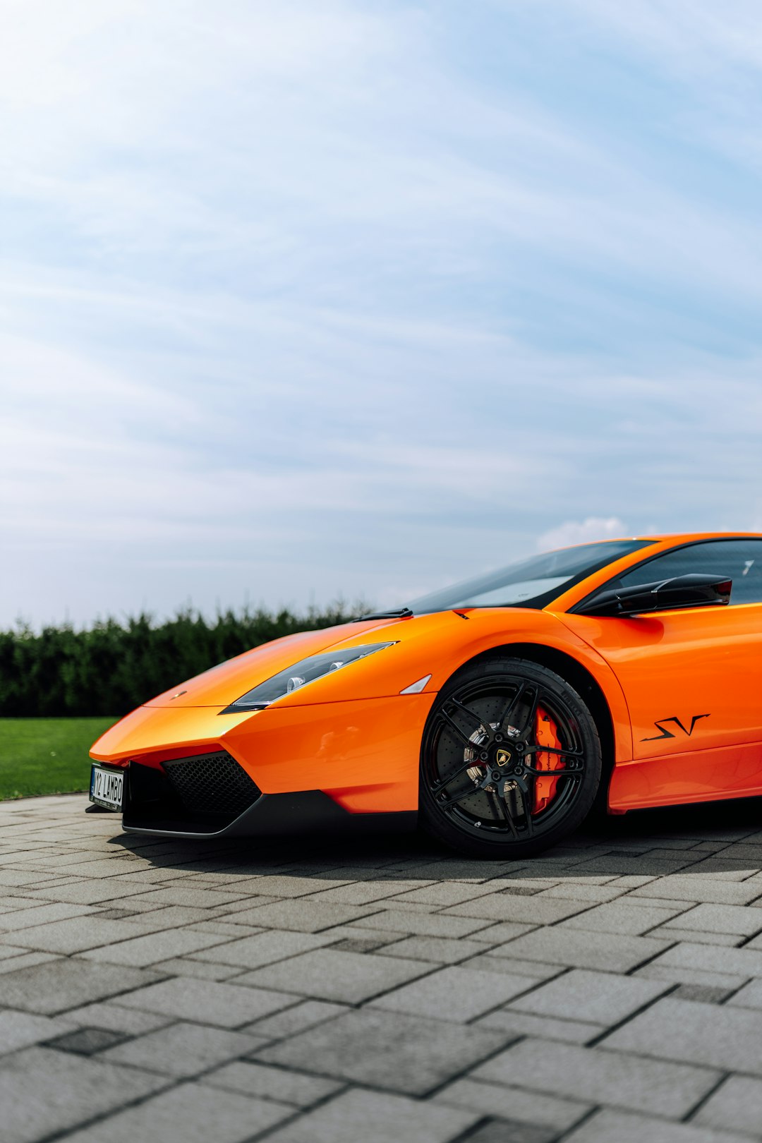 orange lamborghini aventador on road during daytime