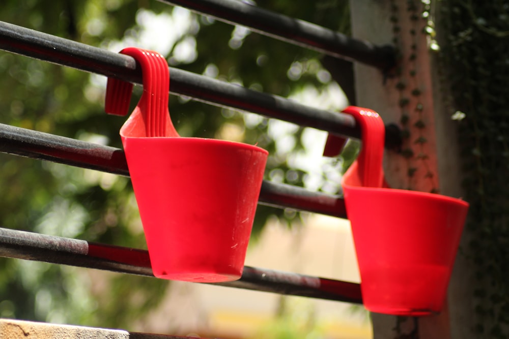 red plastic cup hanging on red metal bar