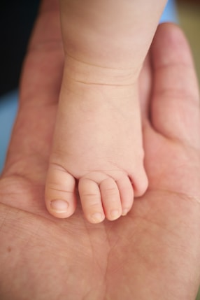 persons feet on brown wooden table