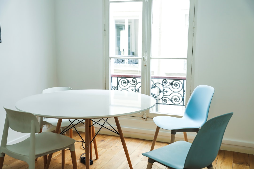 white round table with blue chairs