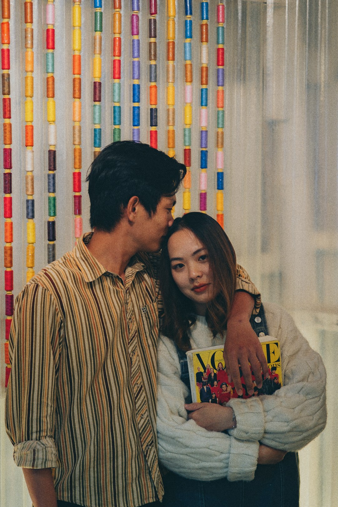 man and woman standing beside white curtain