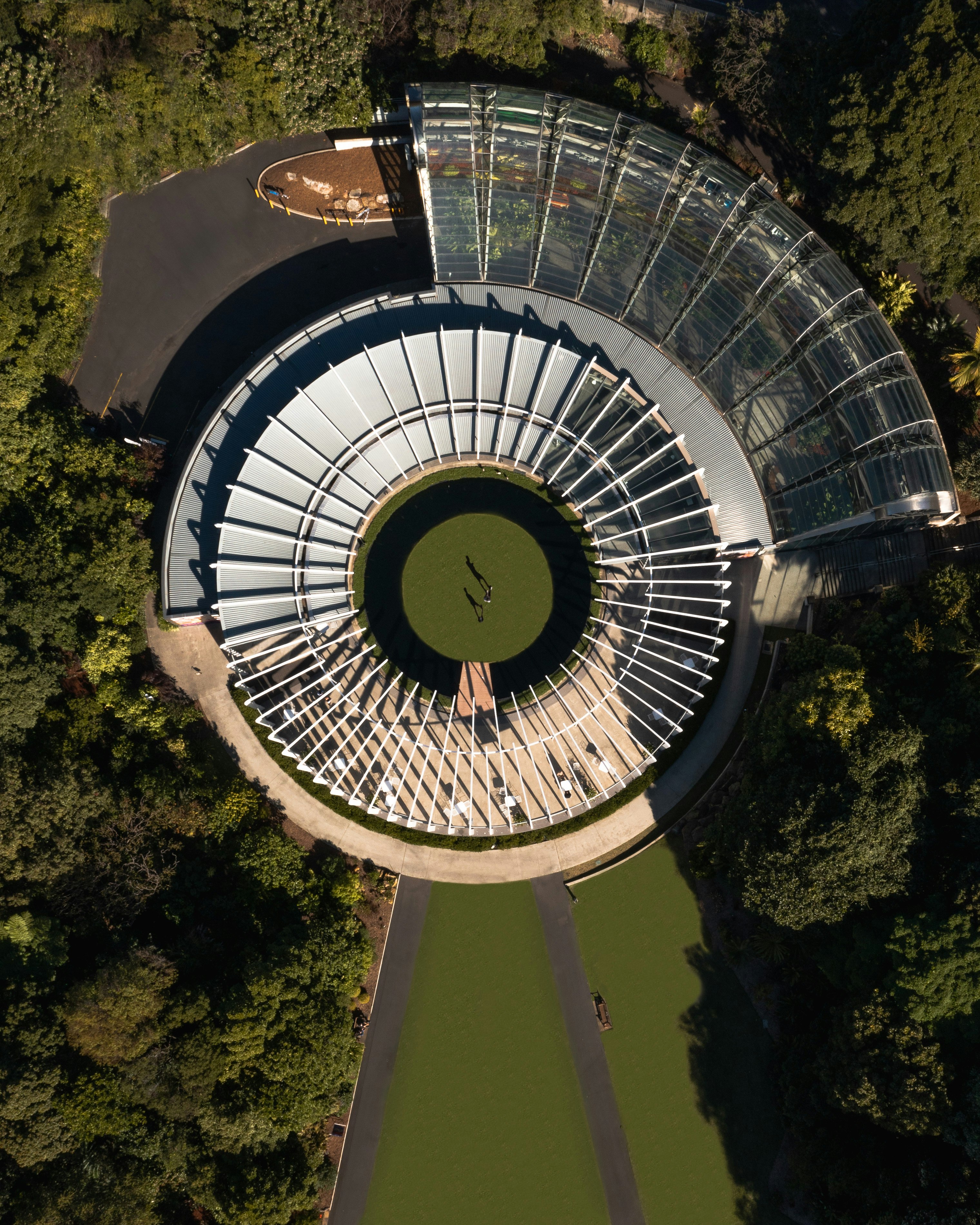 white round building with green trees