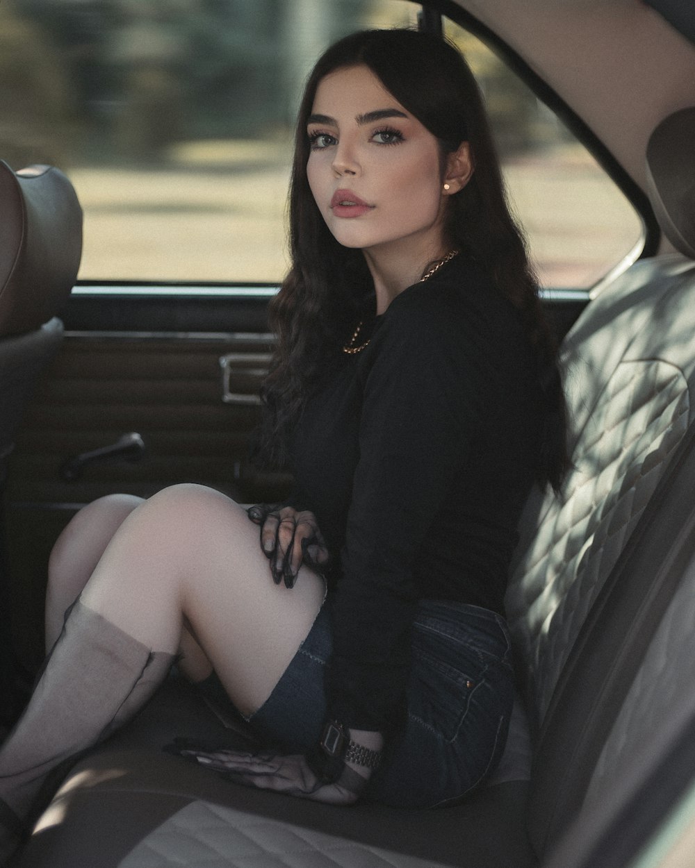 woman in black long sleeve shirt sitting on car seat