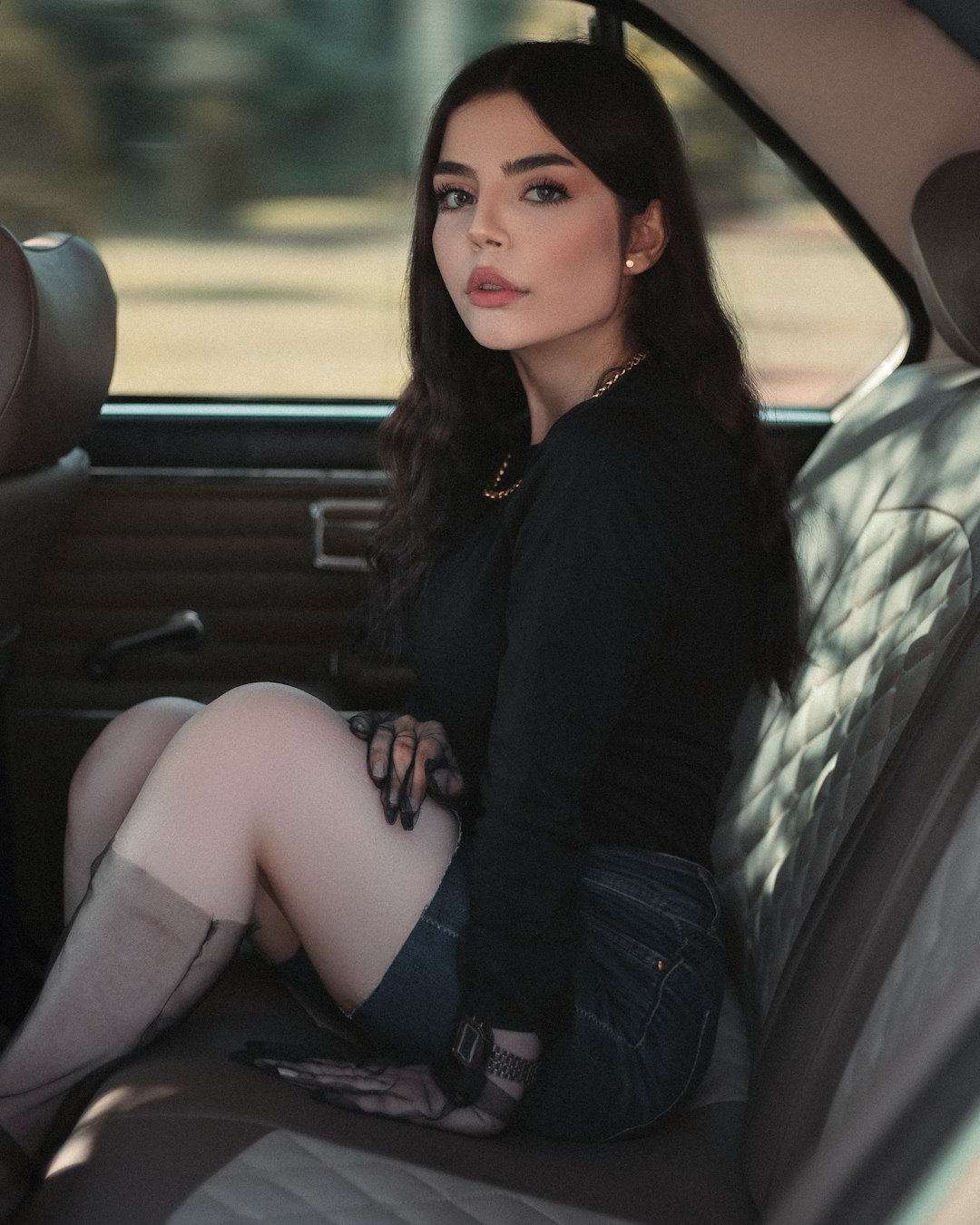 woman in black long sleeve shirt sitting on car seat