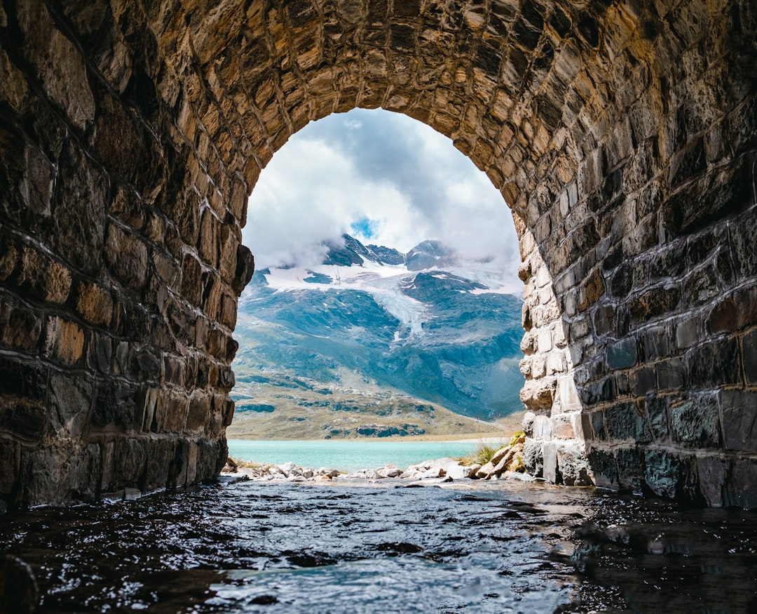 brown concrete arch near sea during daytime