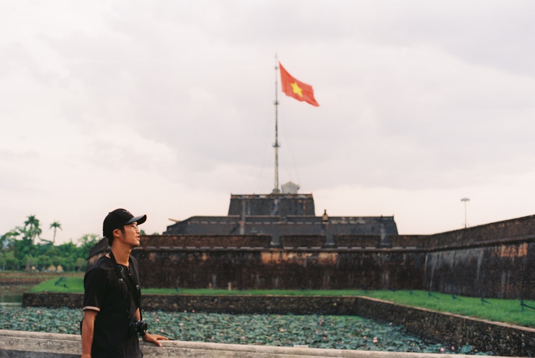 man in black jacket and black cap standing on boat during daytime