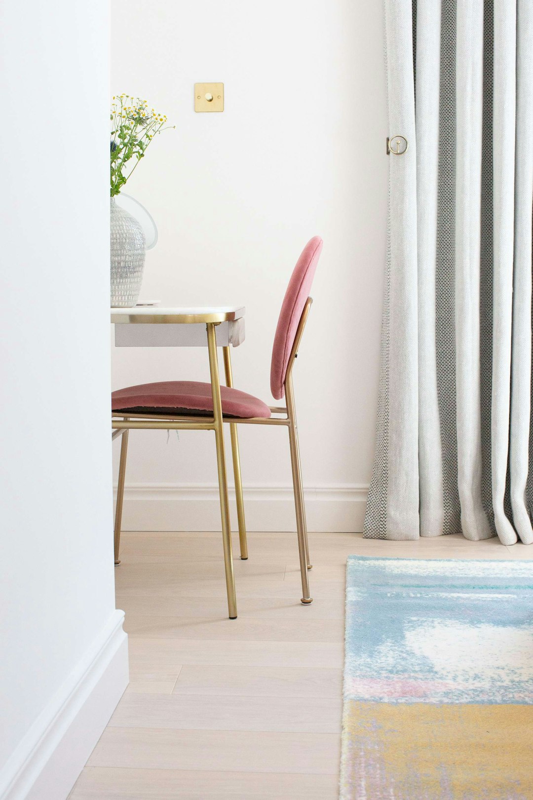 brown wooden chair beside white curtain