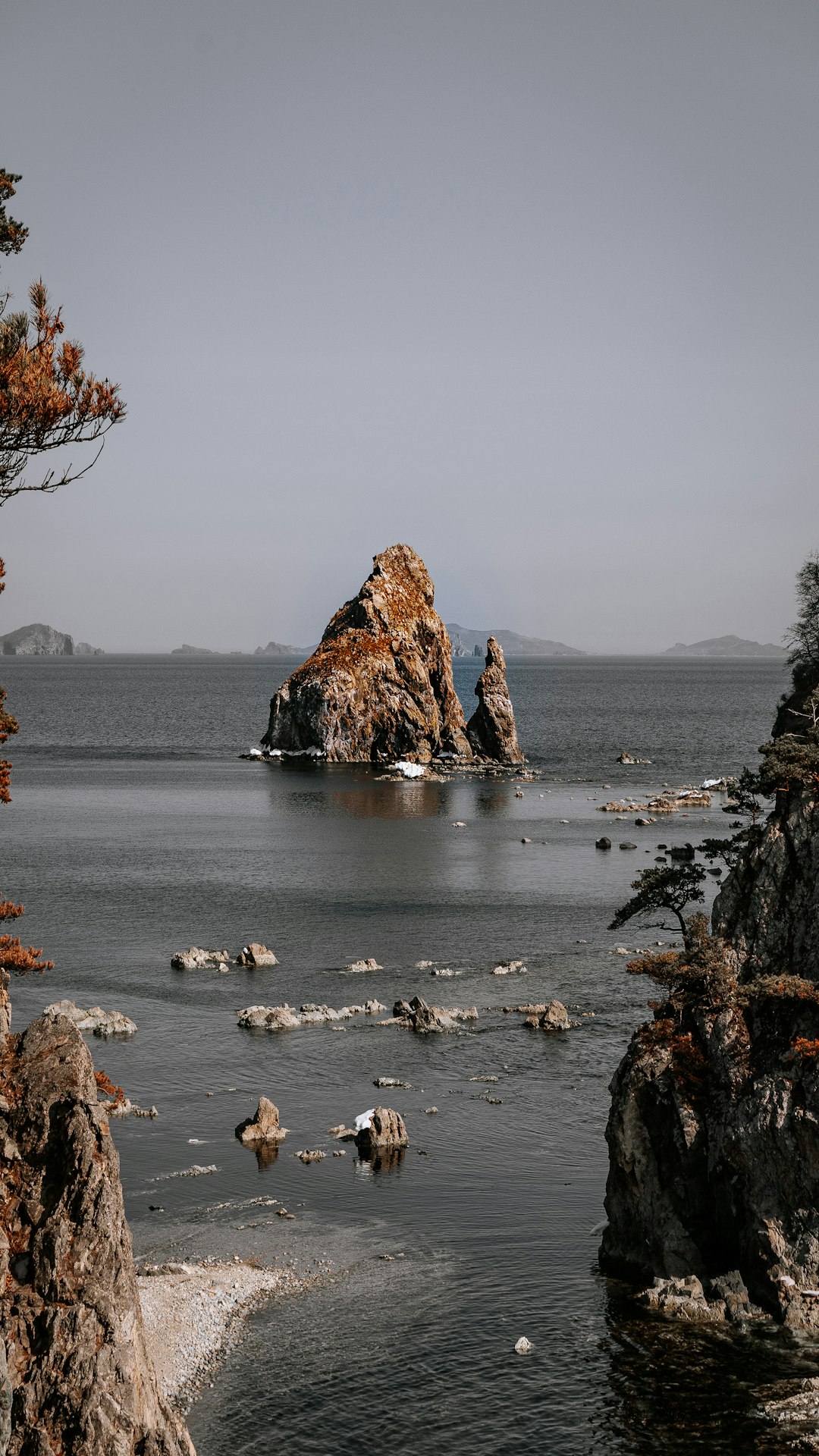 brown rock formation on body of water during daytime