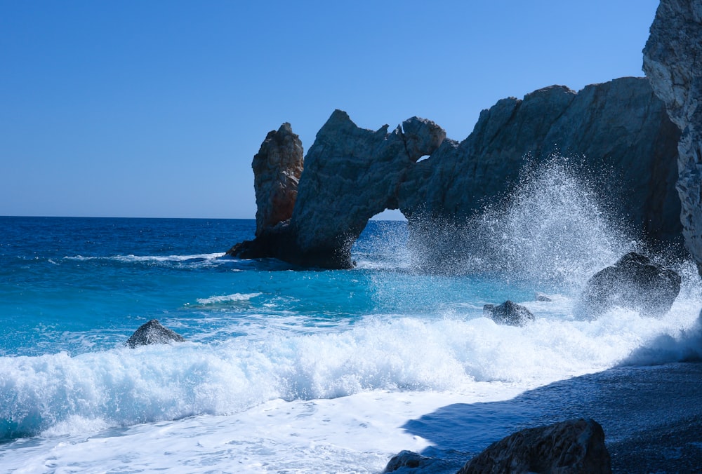 brown rock formation on sea during daytime