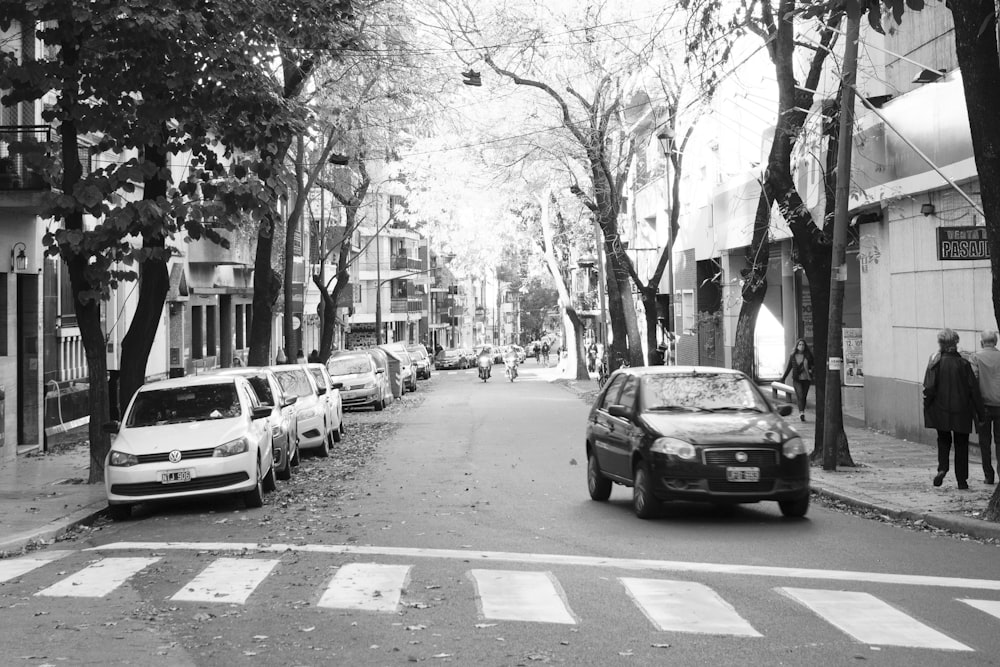 grayscale photo of cars on road