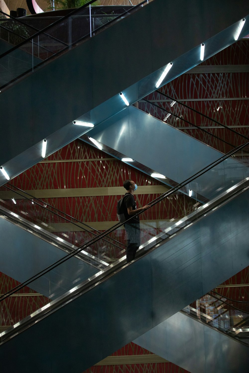 man in black jacket walking on spiral staircase