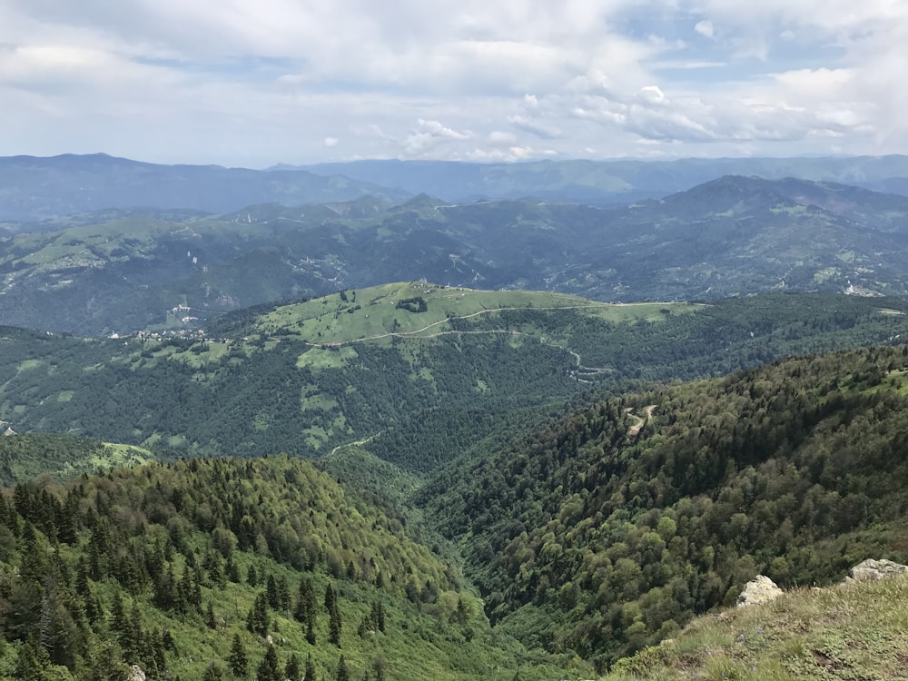 green mountains under white clouds during daytime