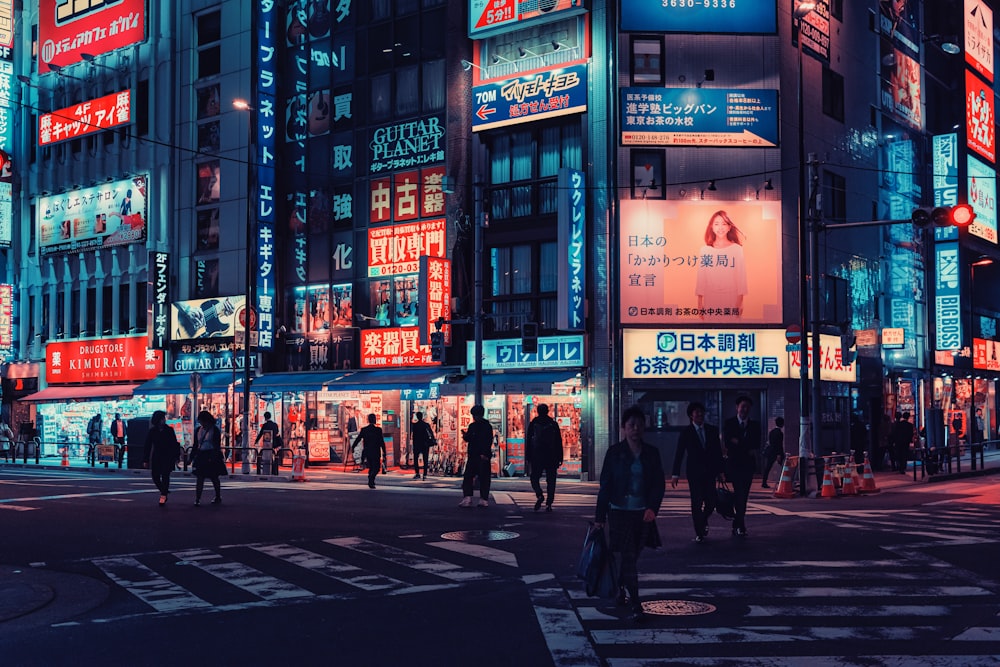 people walking on pedestrian lane during night time