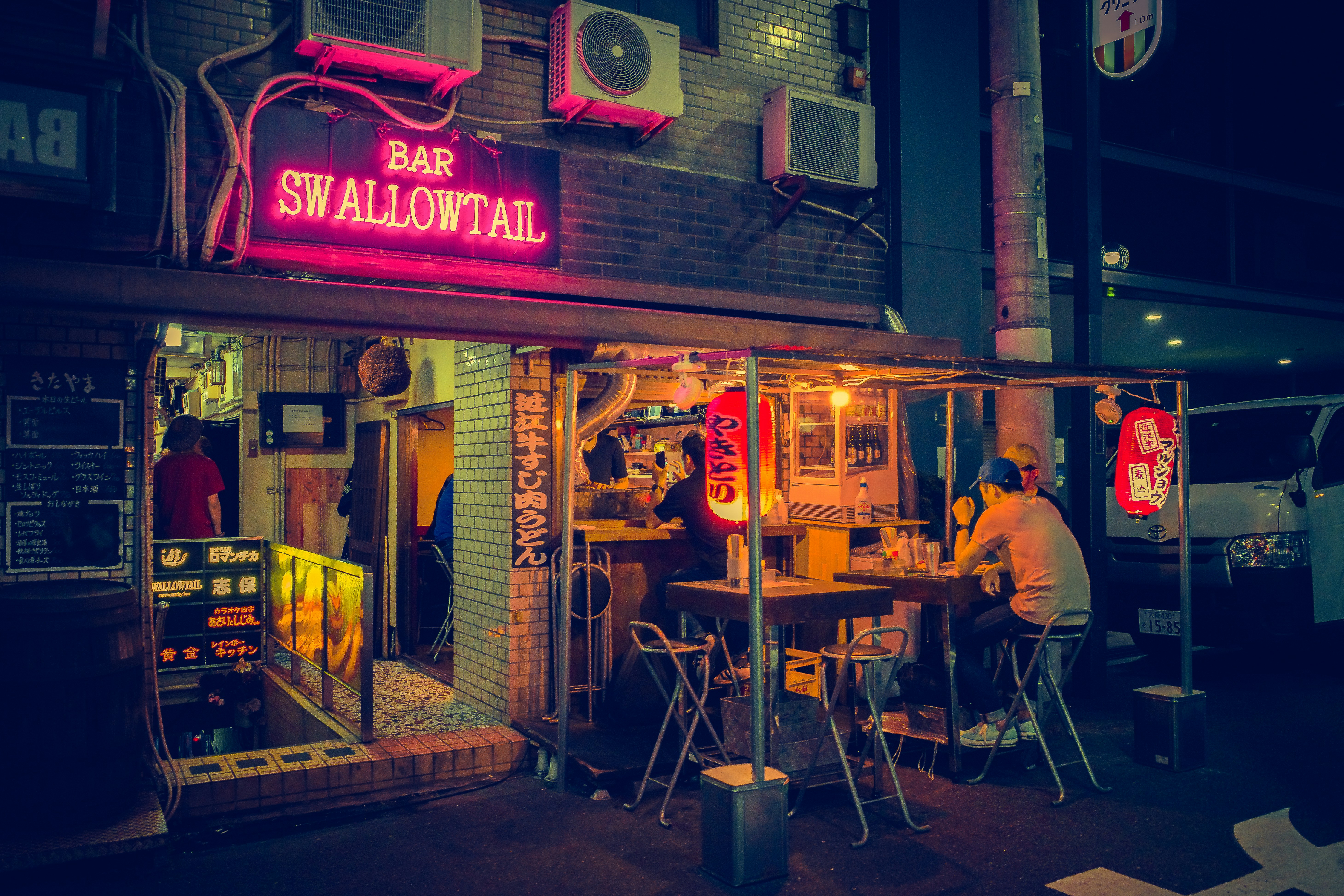 people sitting on chair near store during daytime