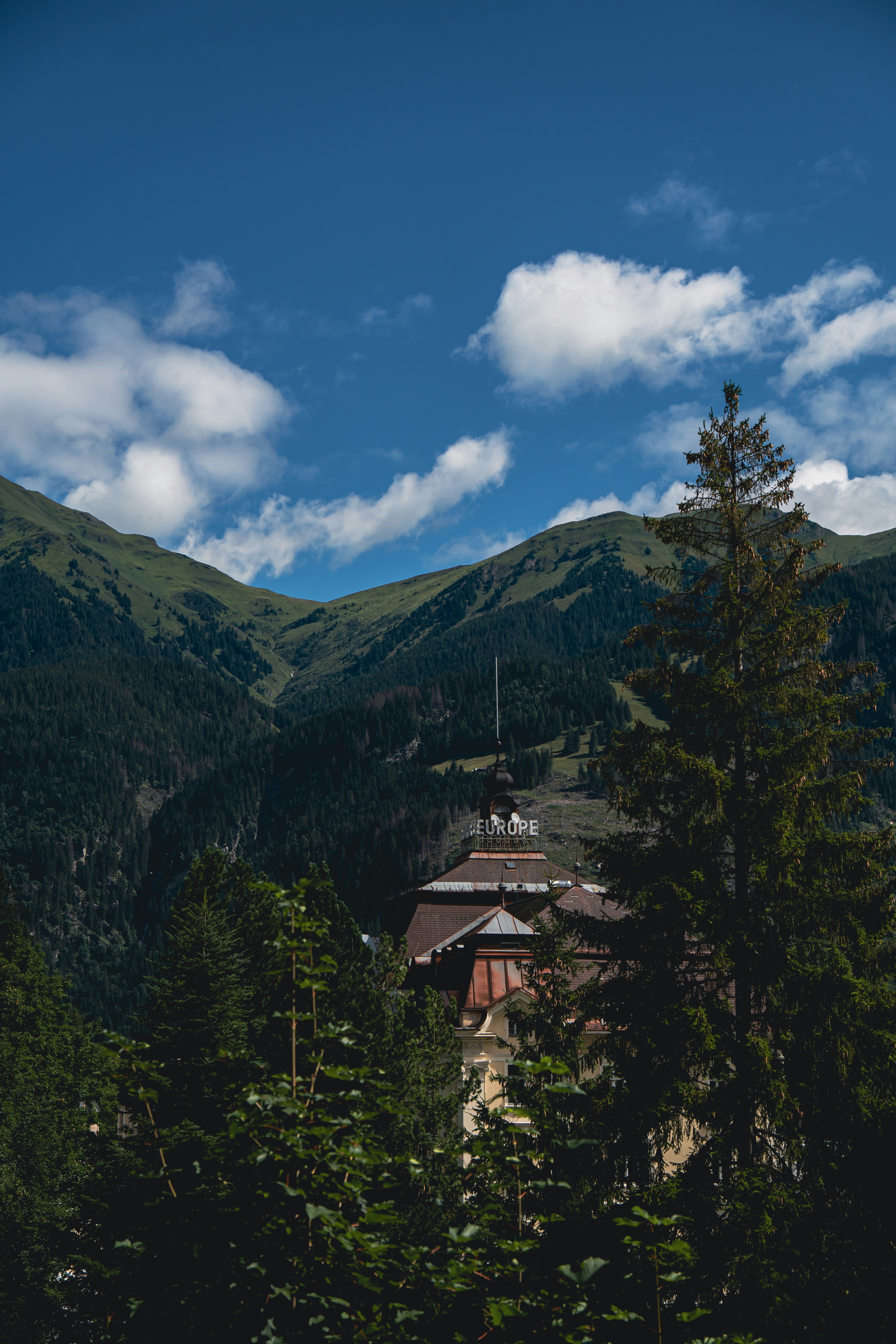 brown and white house on top of mountain under blue sky during daytime