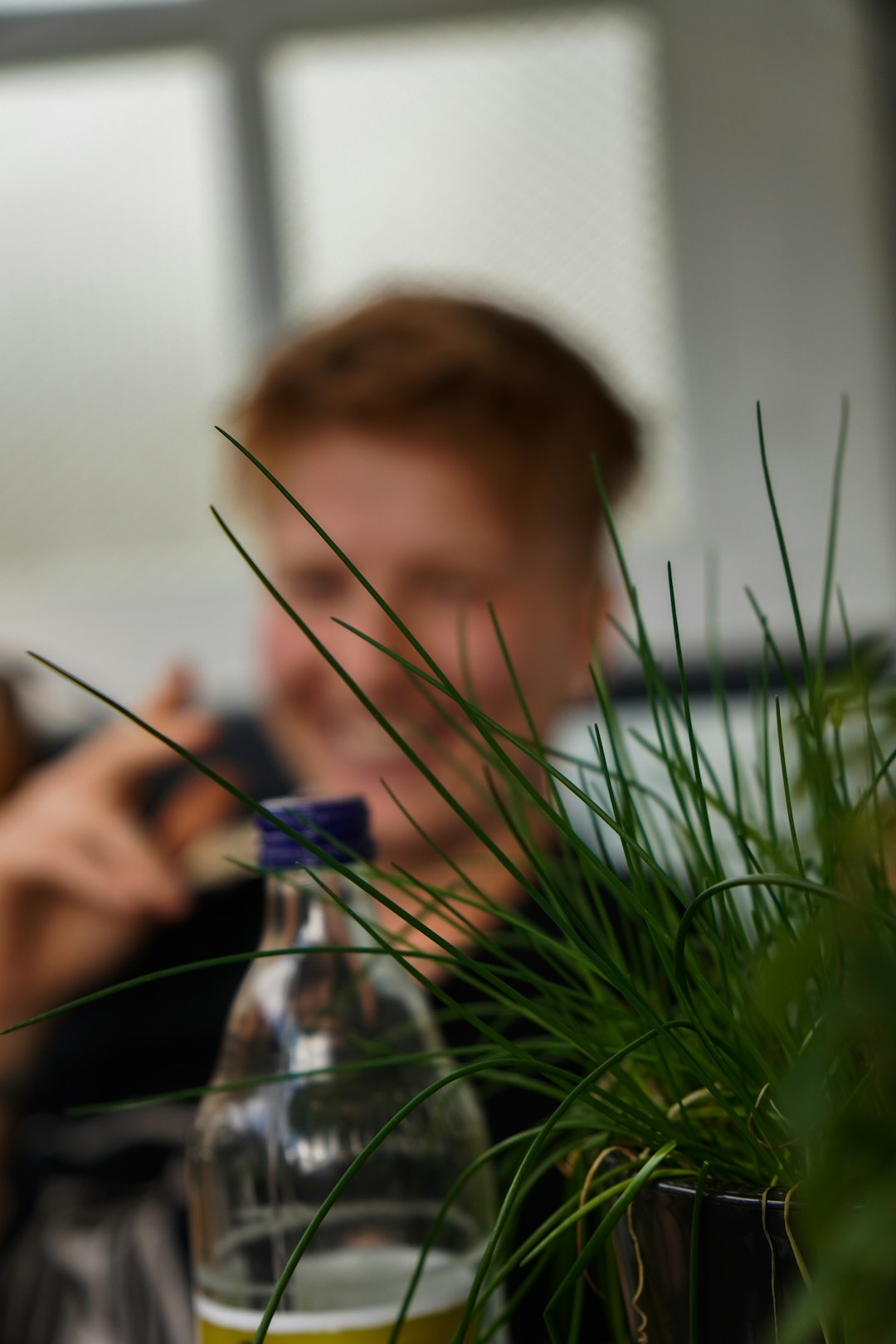 boy in black shirt holding blue flower