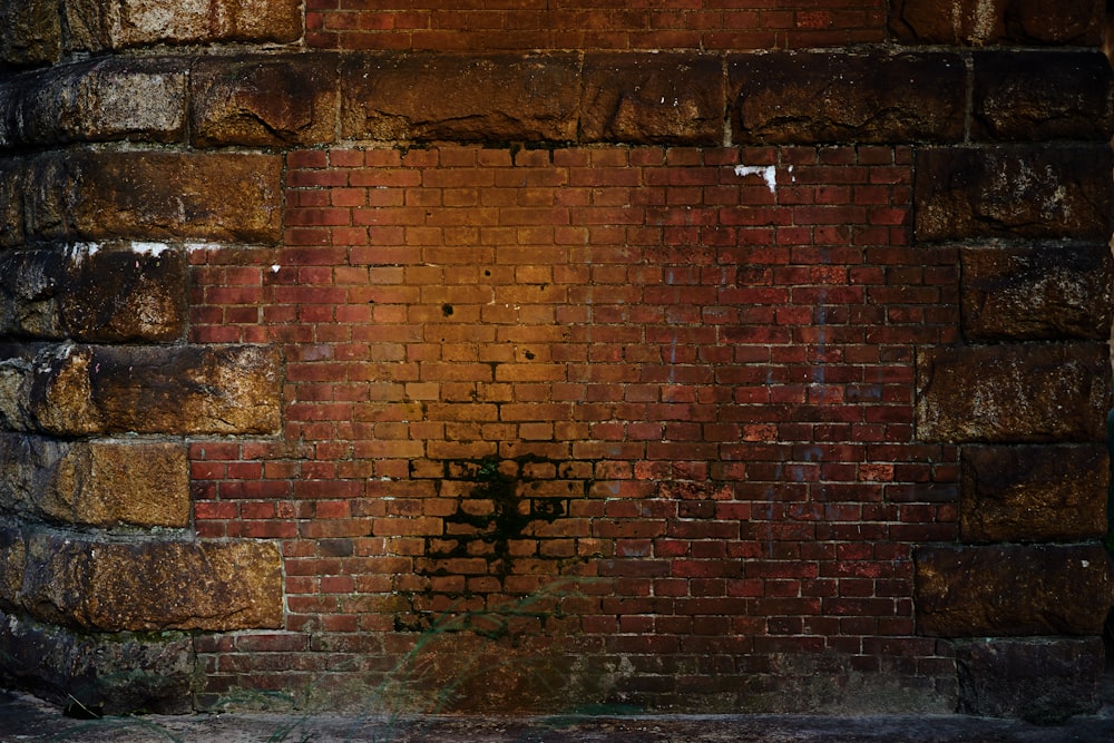 brown brick wall with black and brown paint