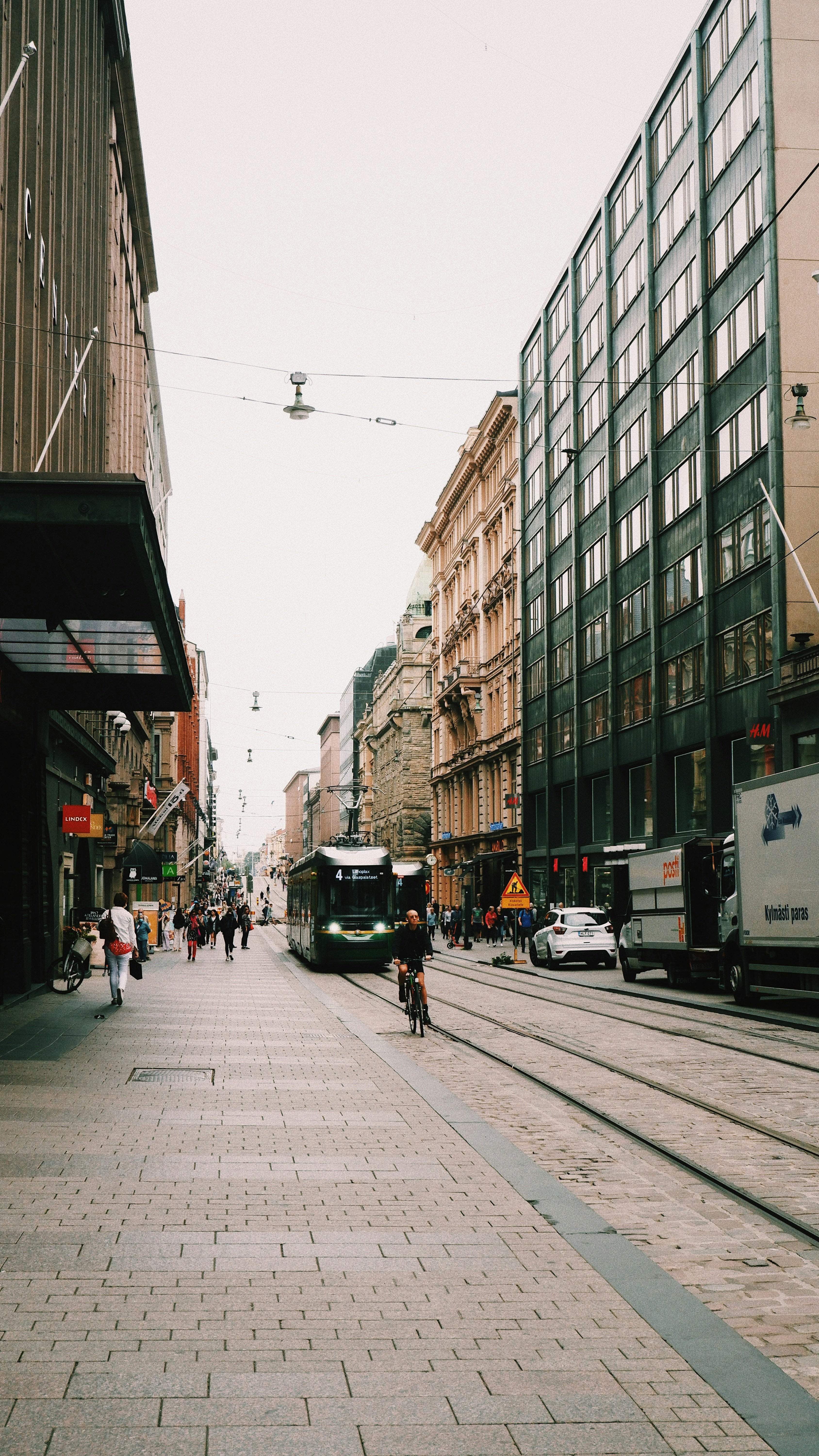 people walking on sidewalk near buildings during daytime