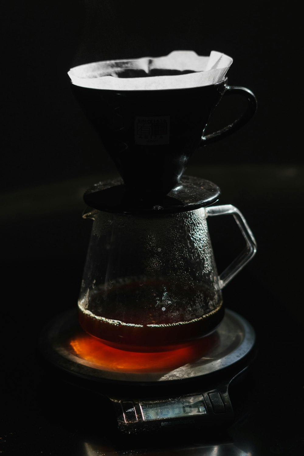 clear glass mug with brown liquid