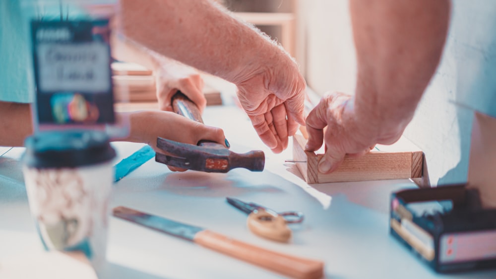 person holding black hand tool