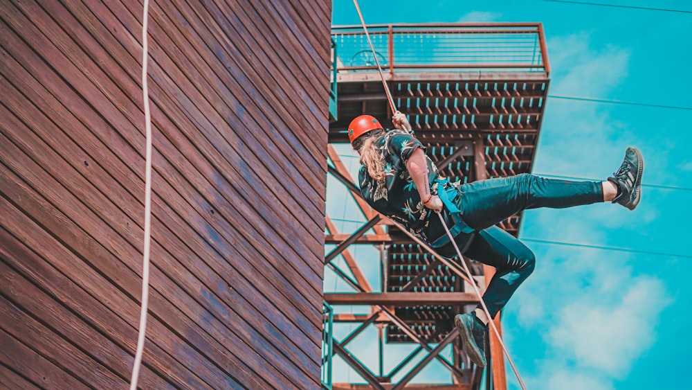 a man climbing up the side of a tall building