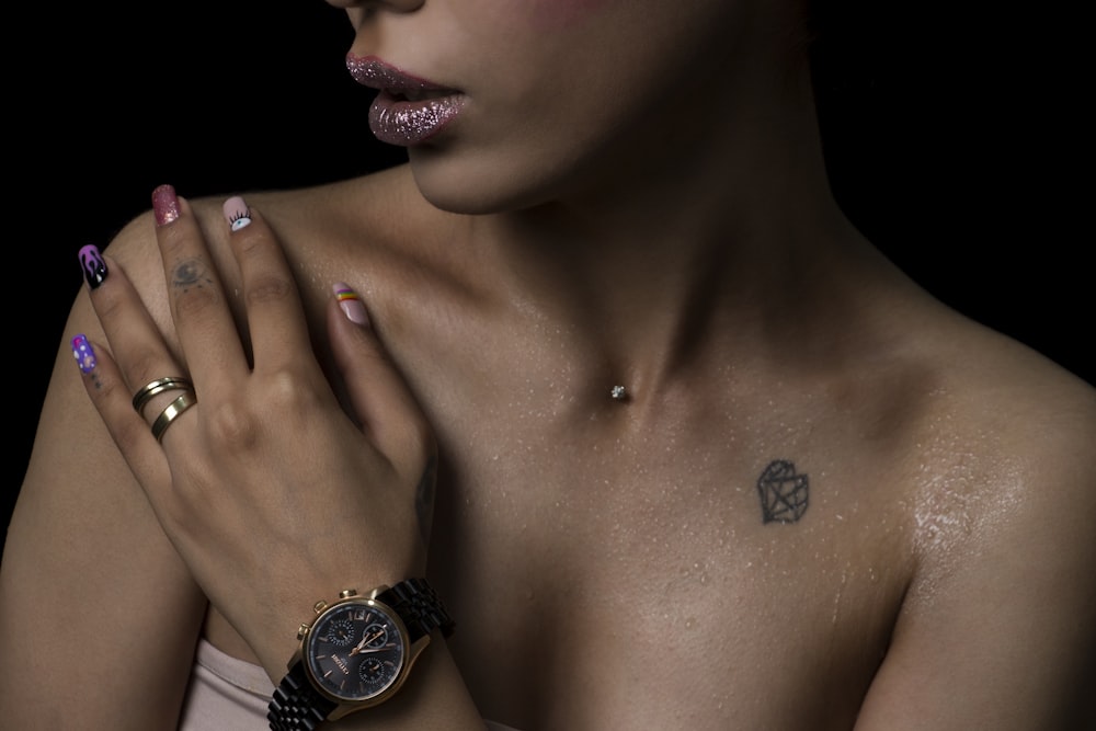 topless woman wearing silver round analog watch