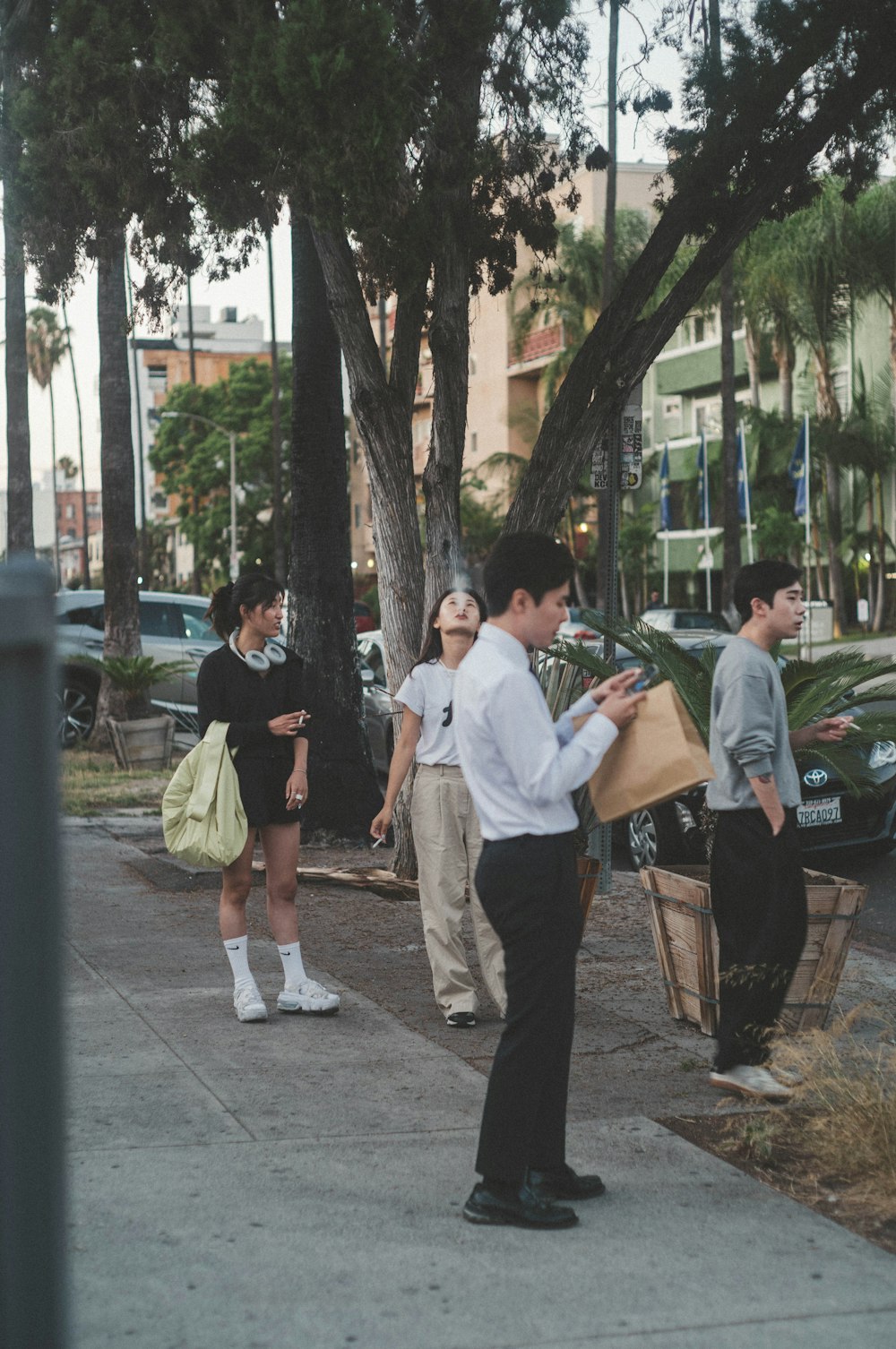 man in white button up t-shirt and black pants standing beside man in white t