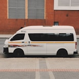 white van parked near brown building