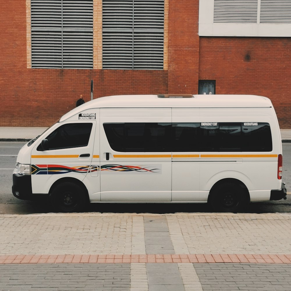 white van parked near brown building