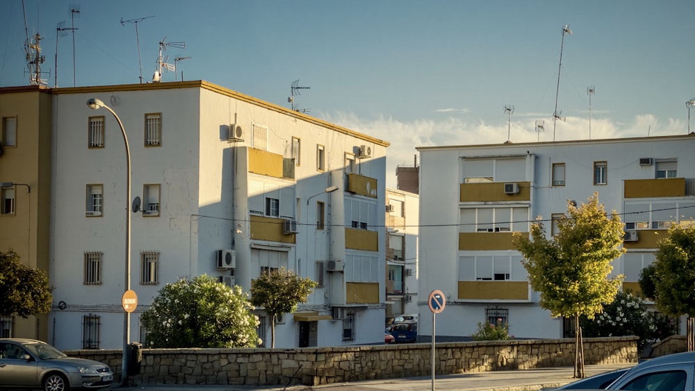 white concrete building near green trees under blue sky during daytime